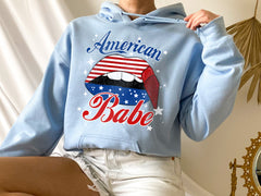 light blue hoodie with america lip that says american babe - HighCiti