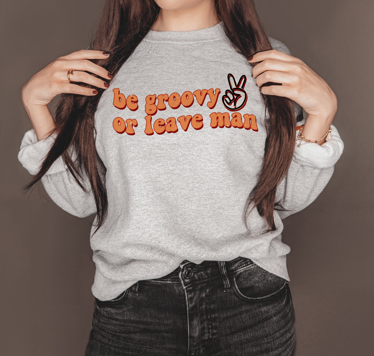 Grey sweatshirt with a peace sign that says be groovy or leave man - HighCiti