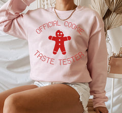 pink sweater with a gingerbread that says official cookie taste tester - HighCiti