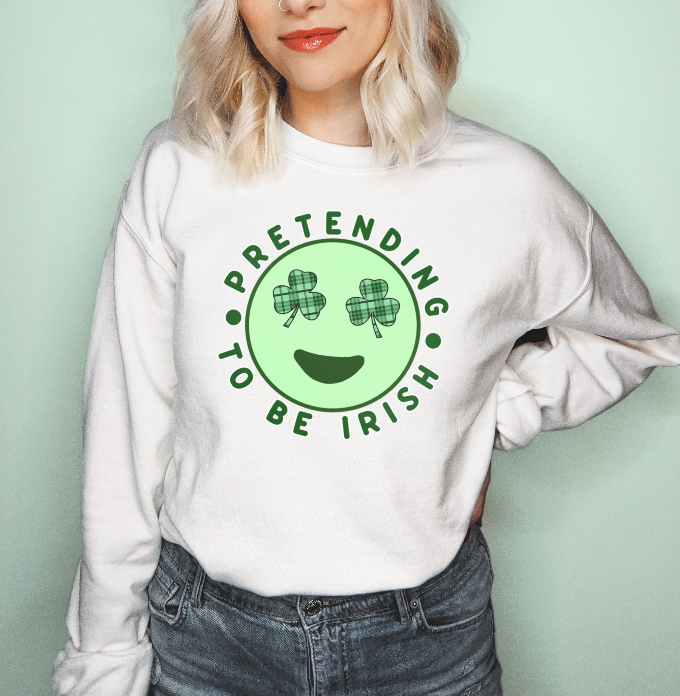White sweatshirt with a shamrock leaf and a emoji saying pretending to be irish - HighCiti