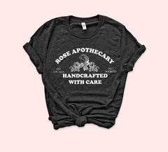 Heather black shirt with roses that says rose apothecary handcrafted with care - HighCiti