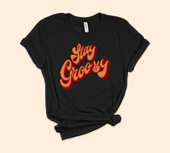 Black shirt that says stay groovy with a retro font - HighCiti