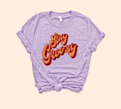 Heather lilac shirt that says stay groovy with a retro font - HighCiti