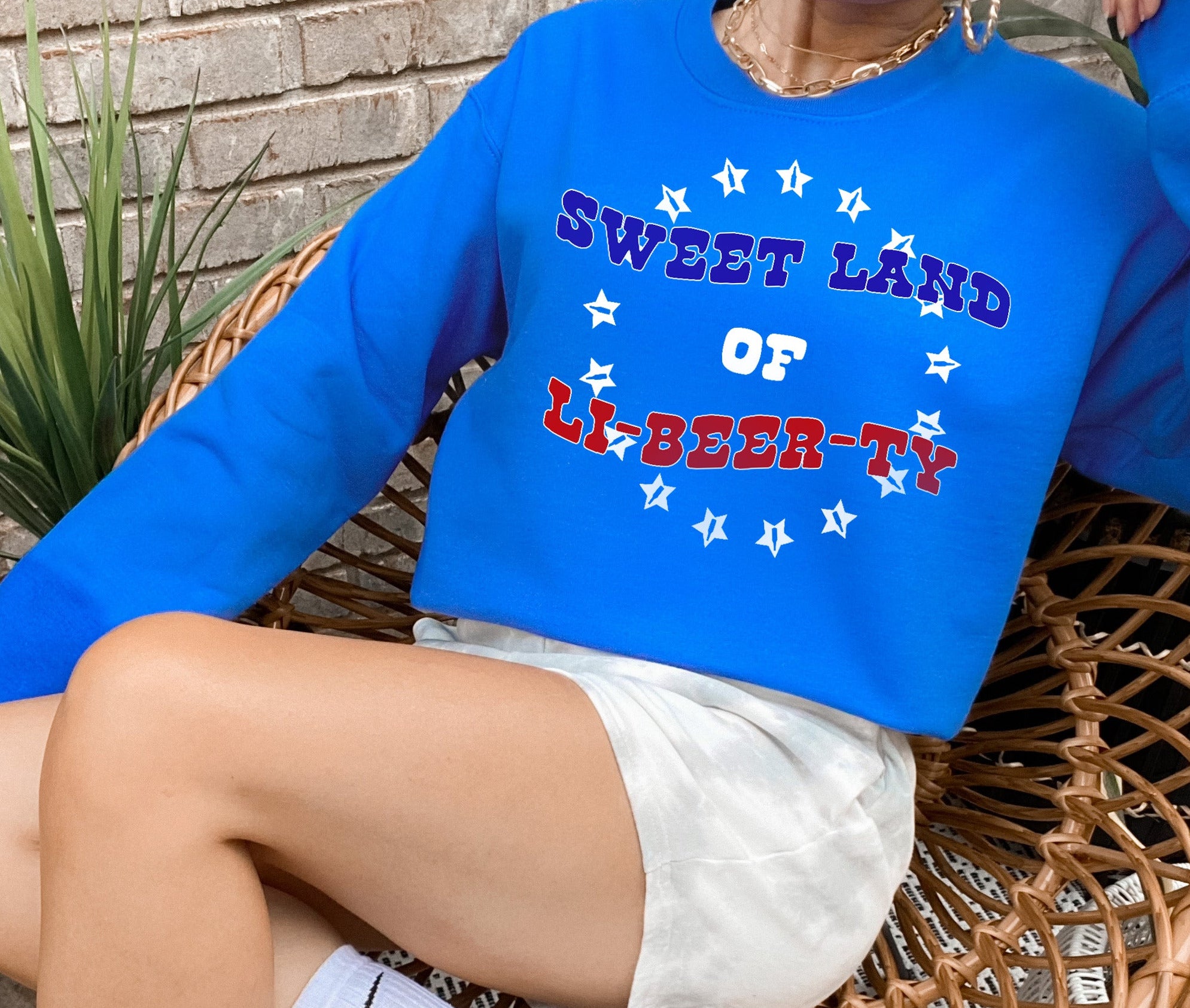 royal blue sweater that says sweet land of li-beer-ty - HighCiti