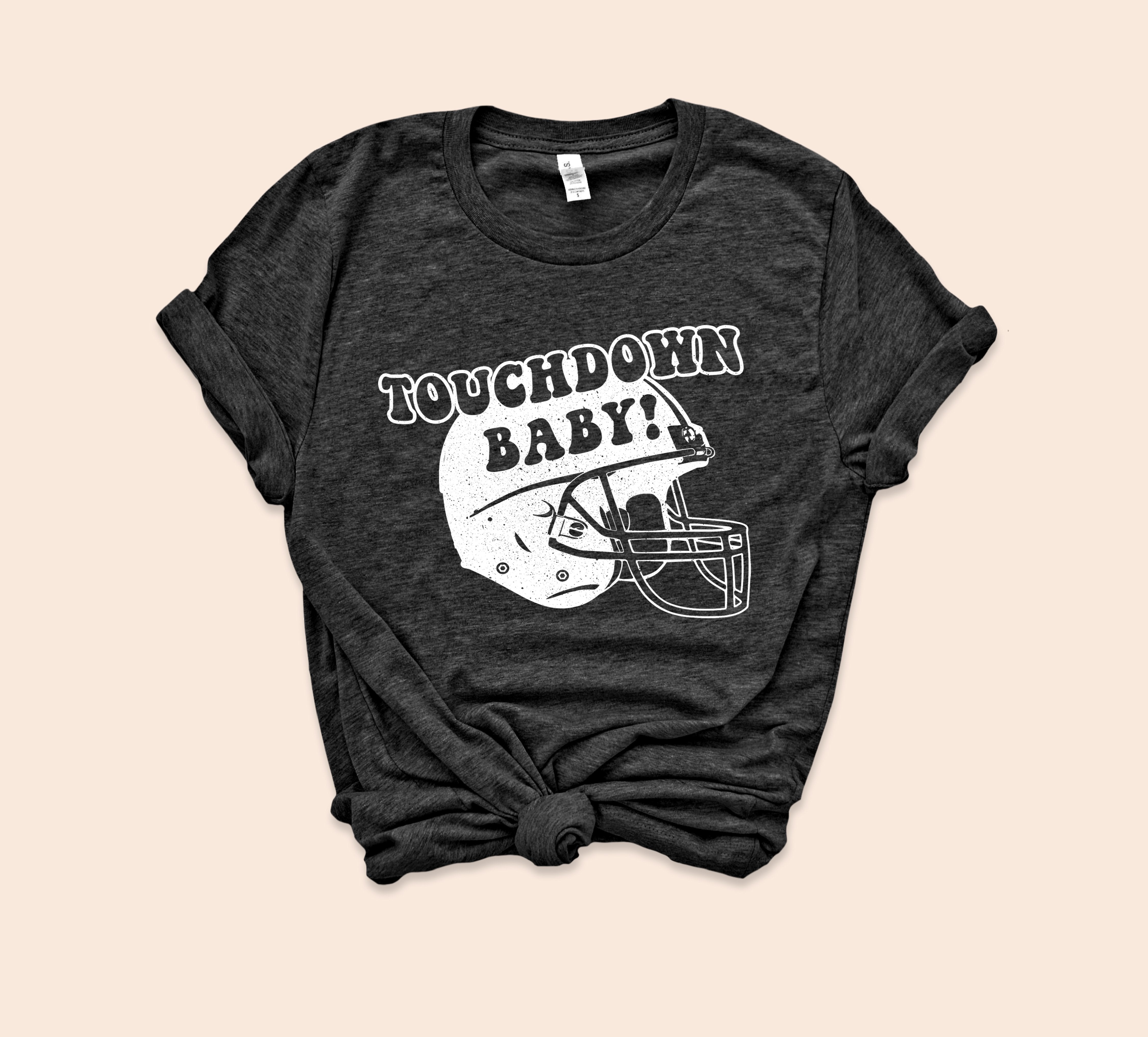 Heather black shirt with football helmet that says touchdown baby - HighCiti