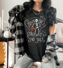 Black shirt with a skeleton holding a pumpkin that says trick or treat yo self - HighCiti