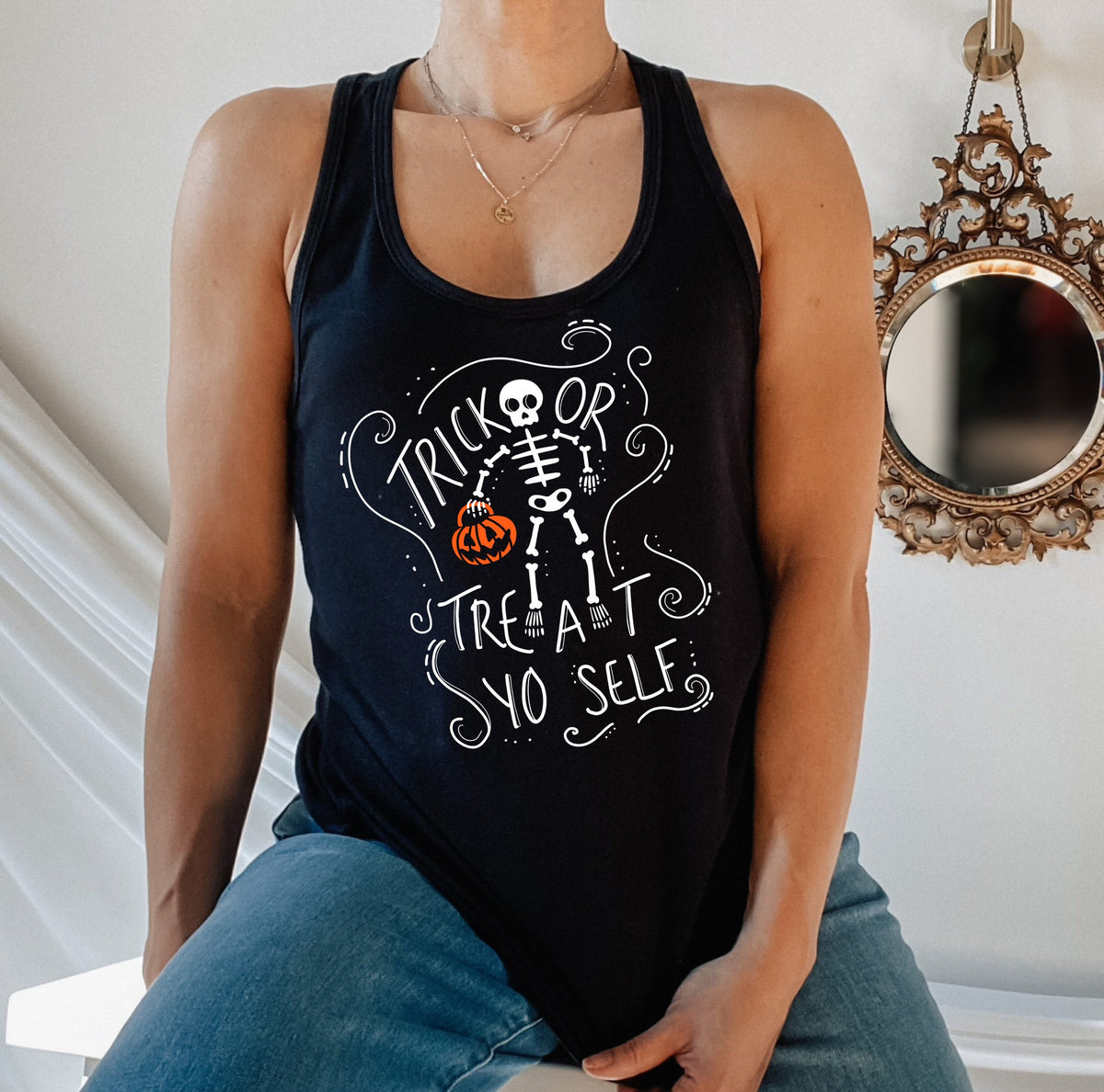 Black tank top with a skeleton holding a pumpkin that says trick or treat yo self - HighCiti