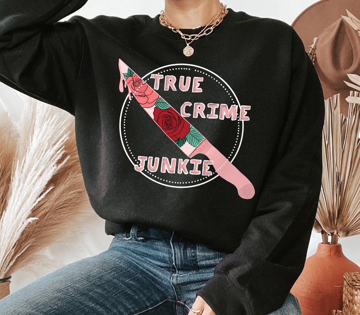 black sweater with a knife that says true crime junkie - HighCiti