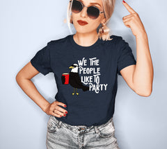 Heather navy shirt with a bird drinking that says we the people like to party - HighCiti